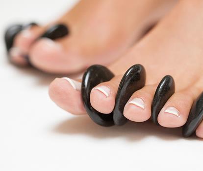 Close-up of well-groomed feet with painted toenails.