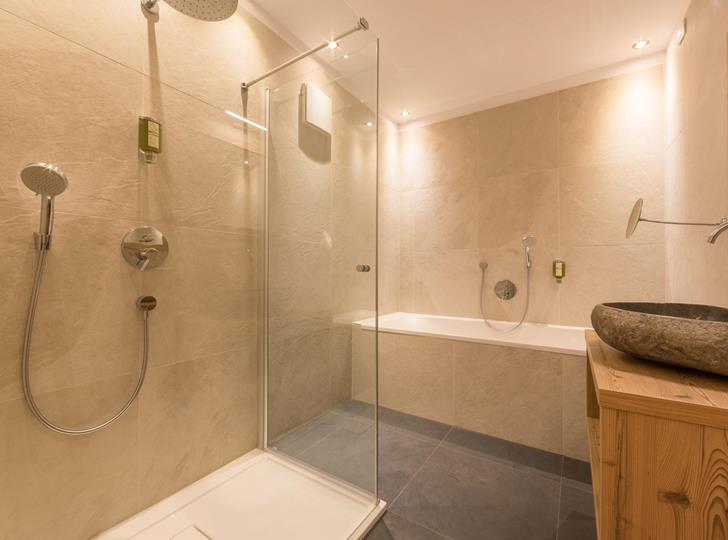 Bagno della Suite Natura con lavabo, doccia e vasca da bagno.