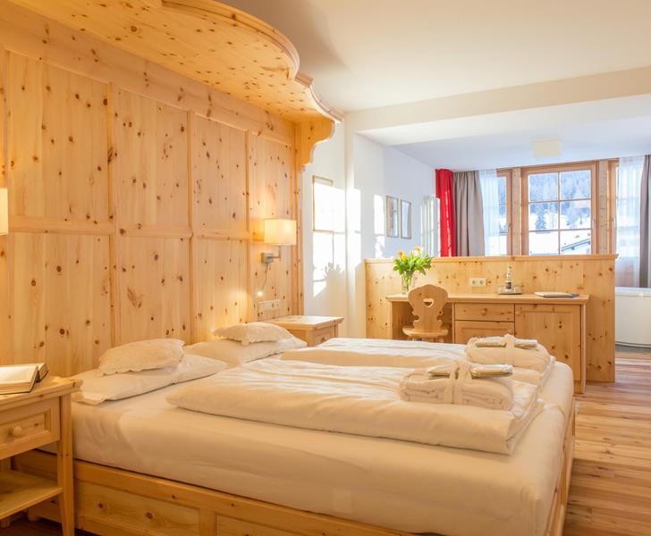 Romantic Suite with double bed, wood panelling and a cosy seating area.