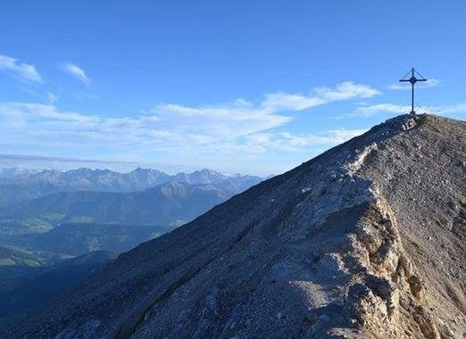Dürrenstein with summit cross and views of the surrounding mountain landscape.