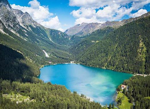 Aerial view of Lake Antholz, the surrounding forests and mountains.