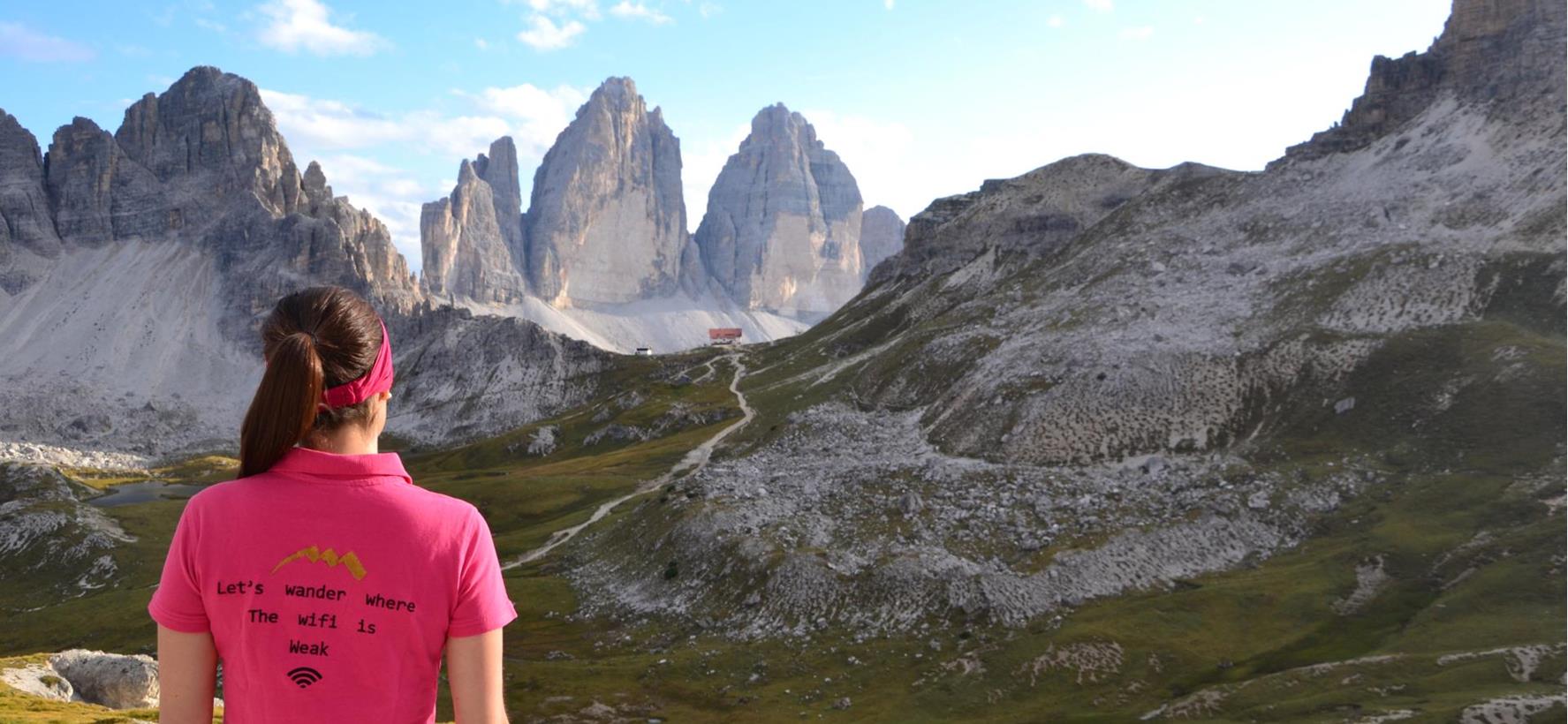 Hiker overlooking the Three Peaks in the Dolomites