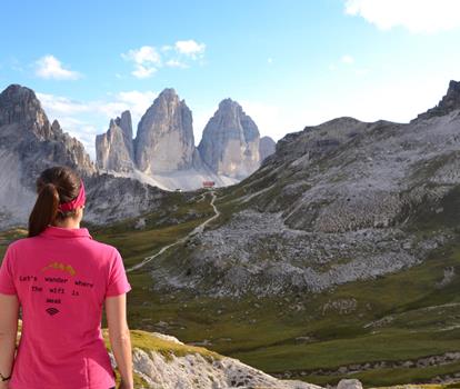 Hiker overlooking the Three Peaks in the Dolomites