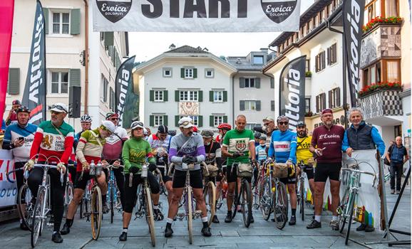 Group of cyclists at the starting line of a cycling race in a city.