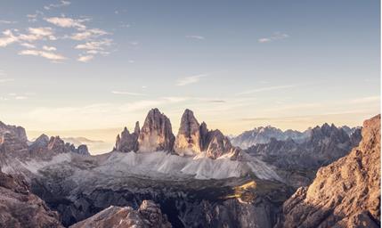 Panoramic view of the Tre Cime di Lavaredo in the Dolomites with an alpine landscape and the soft light of the morning sky.