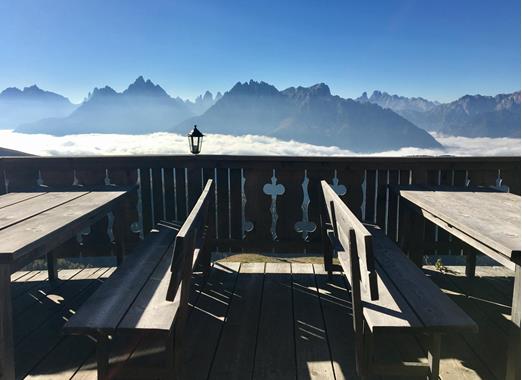 View from a mountain hut terrace over the impressive mountain landscape of the Dolomites.