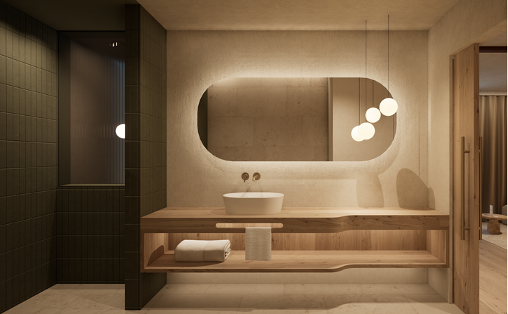 Warmly lit bathroom with a washbasin, a large mirror and a seating area.