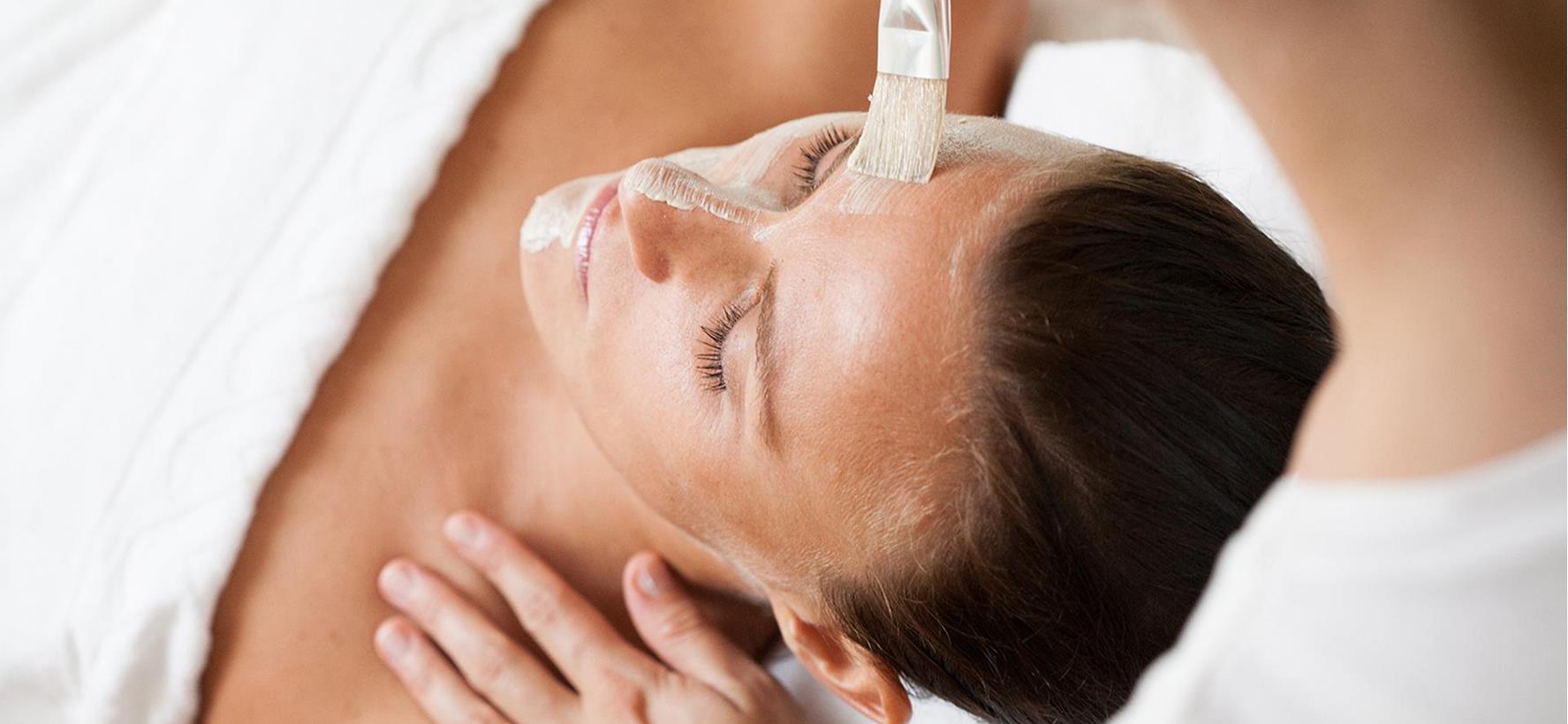 Close-up of a woman’s face during a cosmetic treatment.