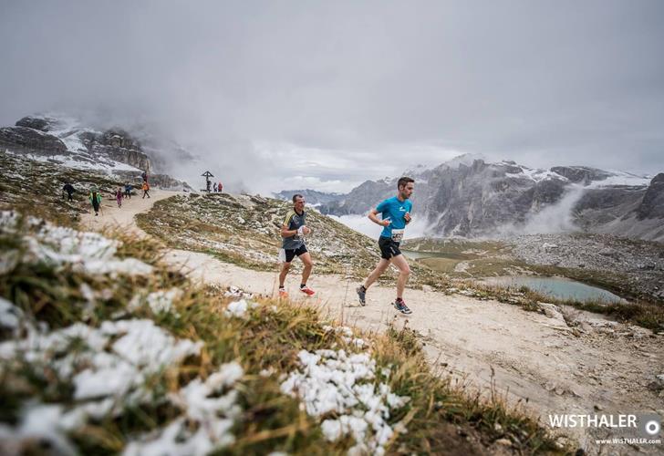 Berglauf im Drei Zinnen Gebiet mit zum Teil schneebedeckter Landschaft.