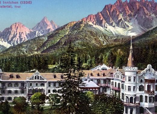 A postcard showing the Wildbad Innichen spa against the backdrop of the Dolomites